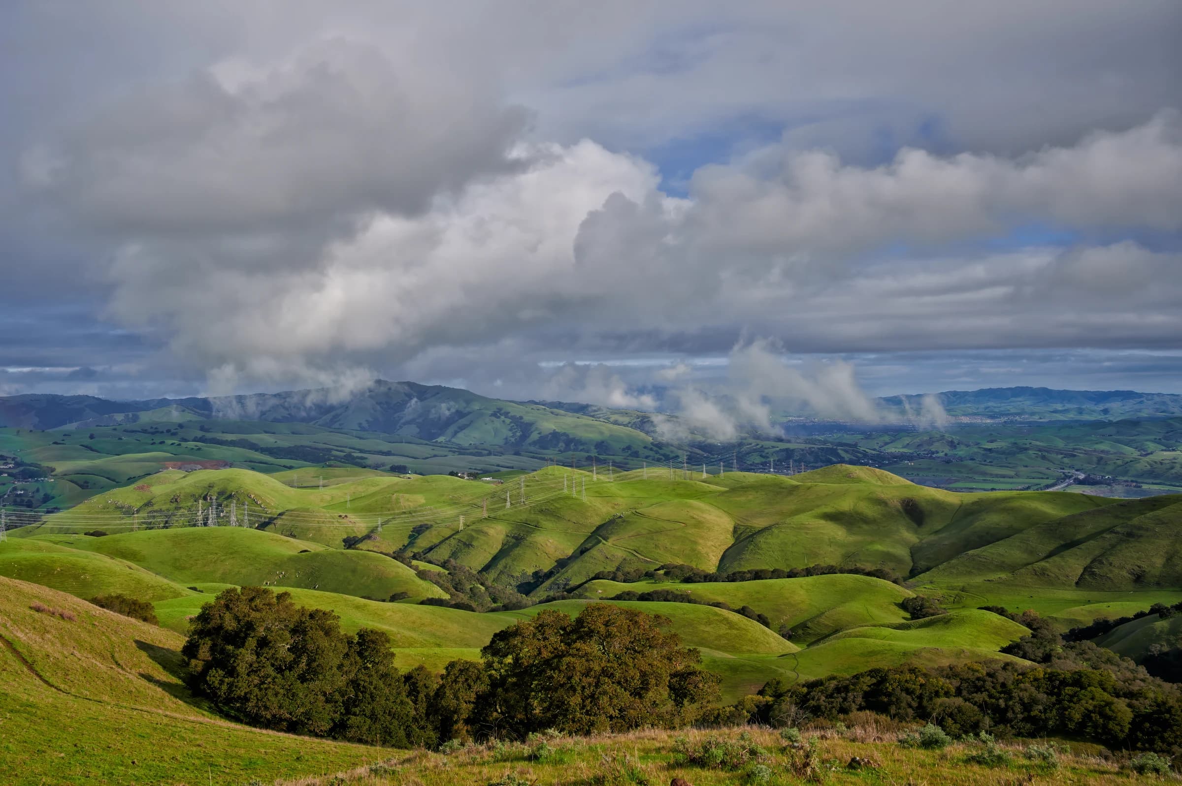 Emerald Hills Under Cloudy Skies